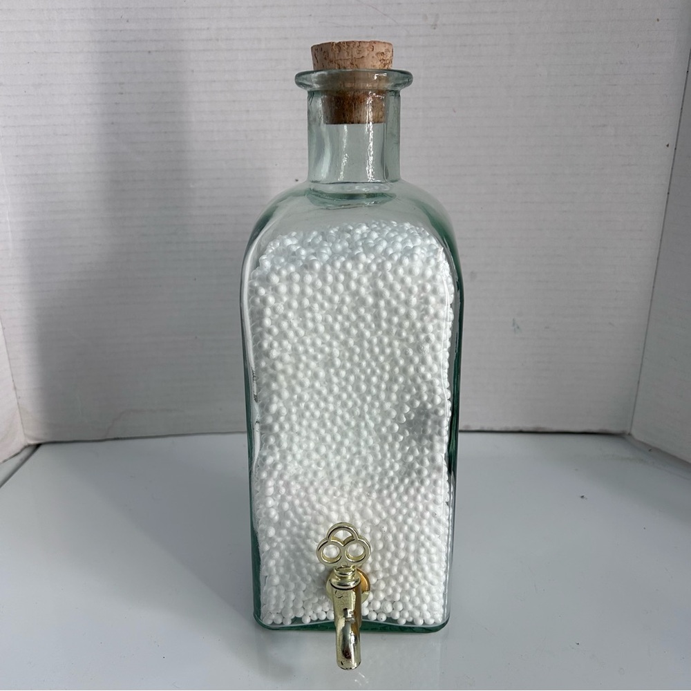 Glass bottle with foam pellets and cork stopper & tap 11” tall